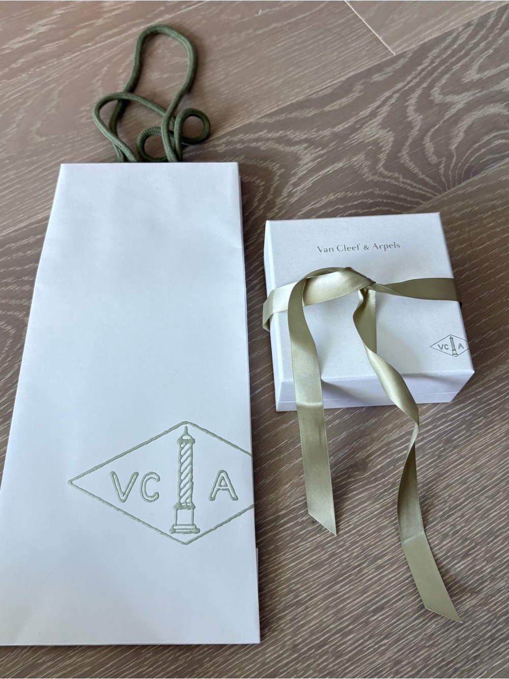 Van Cleef & Arpels pearly gift box with sage green ribbon with shopping bag